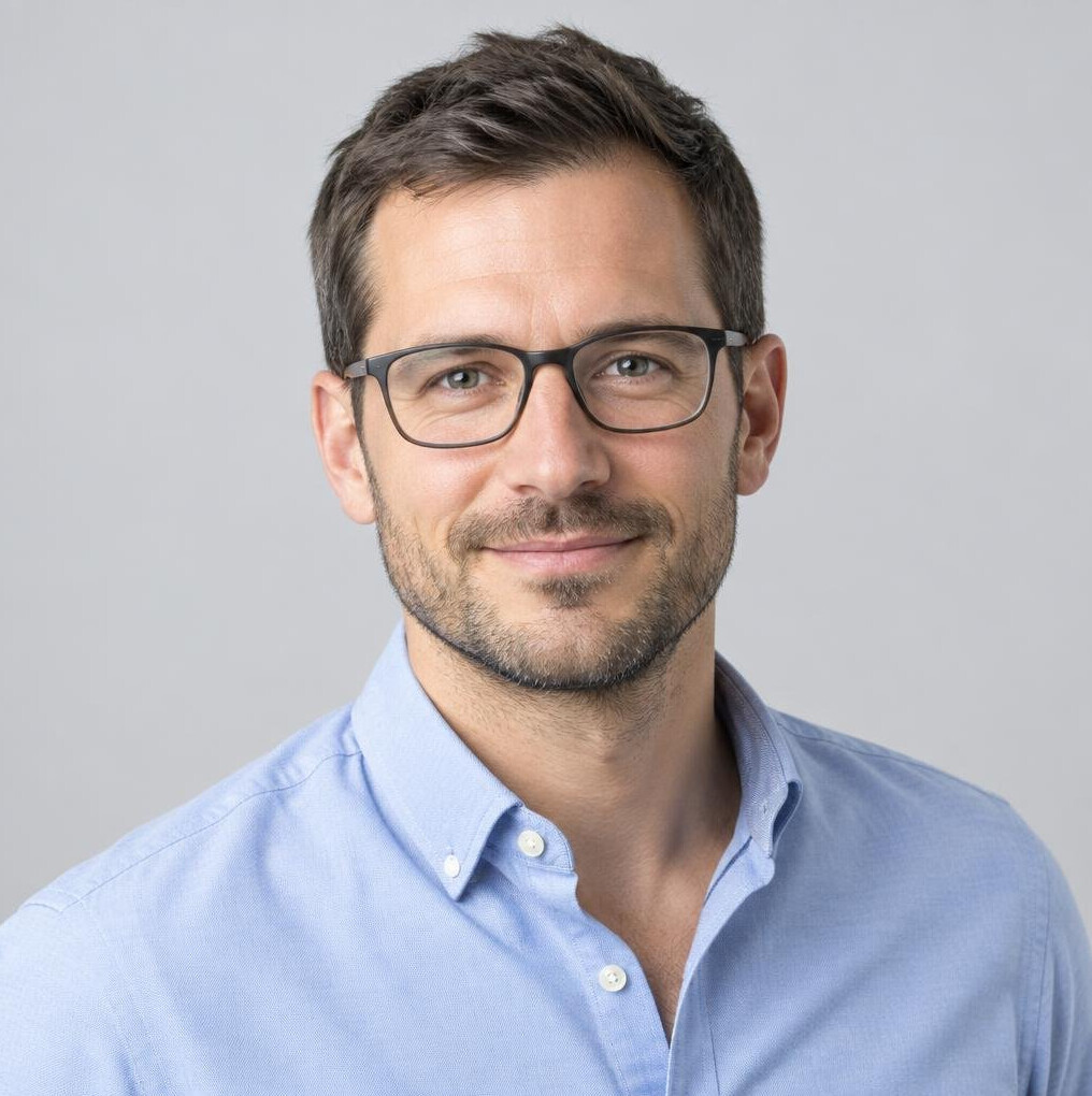 Studio portrait of a man with short hair and glasses